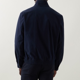Model wearing navy zip-up harrington-style jacket with elasticated hem and cuffs, rear view