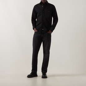 Model wearing Boss Black Casual Owen Solid Logo Shirt in black, styled with dark grey jeans and black shoes.