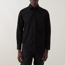 Model wearing Boss Black Casual Owen Solid Logo Shirt in black, featuring point collar, long sleeves, chest patch pocket, and tonal logo badge.