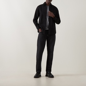 Model wearing Boss Black Casual Owen Solid Logo Shirt in black, styled with dark trousers and black leather shoes.