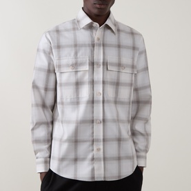 Model wearing Boss Black Casual Owen Flap Pocket Check Shirt in Open White, featuring check print, two chest flap pockets and long sleeves.