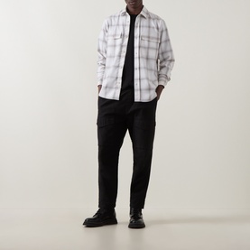Model wearing Boss Black Casual Owen Flap Pocket Check Shirt in Open White with black trousers and black leather shoes.