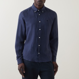 Model wearing Boss Black Casual Liam Logo Linen Shirt in dark blue, long sleeves, button-down collar, chest logo detail, styled with navy trousers.