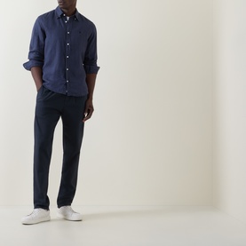 Model wearing Boss Black Casual Liam Logo Linen Shirt in dark blue, styled with navy trousers and white trainers.