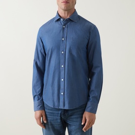 Model wearing Boss Black Casual Rob Denim Shirt in Open Blue, pointed collar, chest pocket, long sleeves, styled with blue jeans.