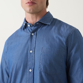Model wearing Boss Black Casual Rob Denim Shirt in Open Blue, showing pointed collar, chest pocket and button fastening detail.