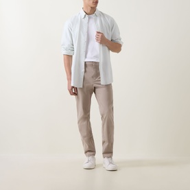 Model wearing Boss Black Casual open beige slim-fit casual trousers, styled with a light blue shirt and white trainers.