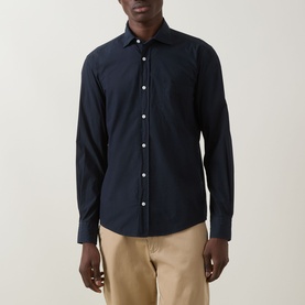 Model wearing Boss Black Casual dark blue cotton casual shirt with spread collar and chest pocket, styled with beige chinos