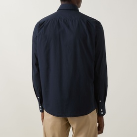 Model wearing Boss Black Casual dark blue cotton casual shirt, back view, with white contrast buttons, styled with beige chinos