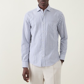 Model wearing Boss Black Casual Rob Striped Shirt in dark blue stripe, point collar, chest patch pocket, paired with light cream trousers