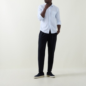 Model wearing Boss Black Casual Rob Striped Shirt in Open Blue with black tapered trousers and navy canvas shoes.
