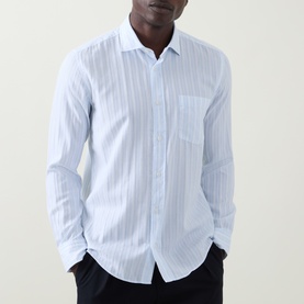 Model wearing Boss Black Casual Rob Striped Shirt in Open Blue, long sleeves, chest pocket, paired with dark trousers