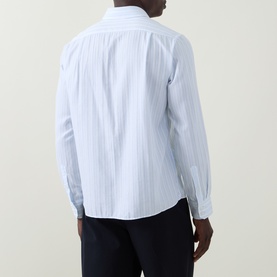 Model wearing Boss Black Casual Rob Striped Shirt in Open Blue, rear view, long sleeves with button cuffs, styled with dark trousers.
