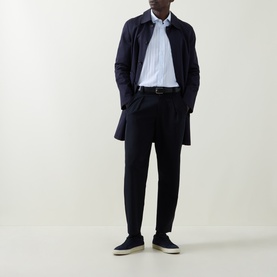 Model wearing Boss Black Casual Rob Striped Shirt in Open Blue with navy coat, tapered trousers and navy slip-on shoes.