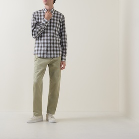 Model wearing Boss Black Casual Kai Pleated Trousers in Dark Beige, straight-leg fit with twin front pleats, styled with a blue check shirt and white