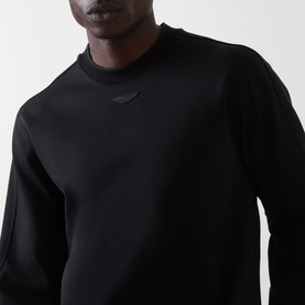 Model wearing Boss Black Casual black cotton crew neck sweatshirt with subtle tonal logo patch at chest