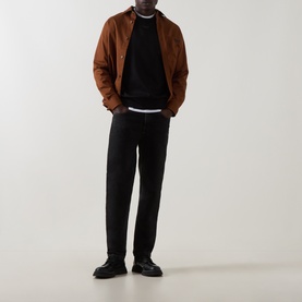 Model wearing Boss Black Casual black cotton crew neck sweatshirt, styled with tan suede bomber jacket and black tapered trousers.