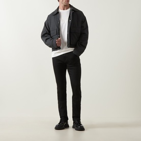 Model wearing Boss Black Casual Taut Logo T-Shirt in Open White, styled with dark bomber jacket and black slim-fit jeans