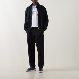 Model wearing Boss Black Casual Taut Logo T-Shirt in white, styled with navy zip jacket, black trousers and navy trainers.