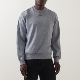 Model wearing Boss Black Casual Soleri Logo Sweatshirt in Open Grey, crew neck with chest logo, styled with black jeans