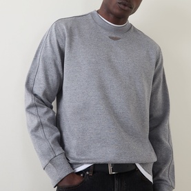 Model wearing Boss Black Casual Soleri Logo Sweatshirt in Open Grey, crew neck with ribbed trims and Wing logo at chest, paired with dark jeans