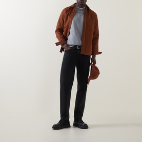 Model wearing Boss Black Casual Soleri Logo Sweatshirt in Open Grey, styled with brown overshirt, black trousers, and black shoes.