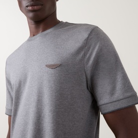 Model wearing Boss Black Casual Thompson Logo T-Shirt in Open Grey, crew neck with tonal chest logo and ribbed cuffs, close-up detail shot