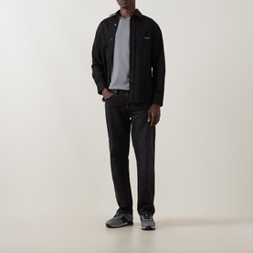 Model wearing Boss Black Casual Thompson Logo T-Shirt in Open Grey, styled with black zip-up jacket, dark trousers and grey trainers.