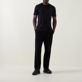 Model wearing Boss Black Casual Thompson Logo T-Shirt in black with black trousers and black trainers.