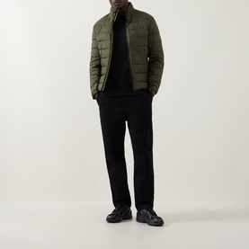 Model wearing Boss Black Casual Thompson Logo T-Shirt in black, styled with olive quilted jacket and black trousers.