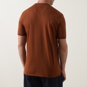 Model wearing Boss Black Casual medium brown cotton crew neck T-shirt, rear view, styled with navy trousers.