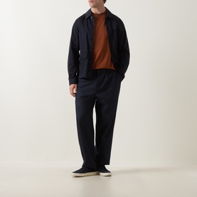 Model wearing Boss Black Casual Medium Brown Crew Neck T-Shirt, styled with navy overshirt, navy trousers, and cream trainers.