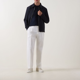 Model wearing Boss Black Casual C-Taut 01 Logo T-Shirt in Dark Blue, styled with navy jacket, white trousers and white trainers