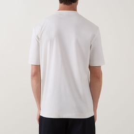 Model wearing Boss Black Casual C-Taut 01 Logo T-Shirt in Open White, rear view, crew neck, short sleeves, paired with navy trousers