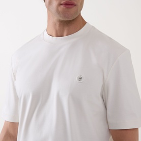 Model wearing Boss Black Casual C-Taut 01 Logo T-Shirt in Open White, crew neck with small chest logo detail, short sleeves.