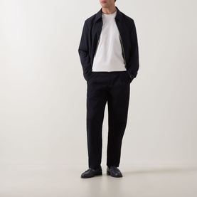 Model wearing Boss Black Casual C-Taut 01 Logo T-Shirt in Open White, styled with navy zip jacket and black trousers.