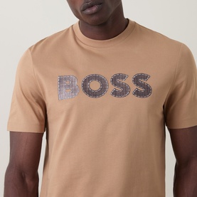 Model wearing Boss Black Casual C-Thompson Logo T-Shirt in medium beige with graphic BOSS logo print on chest, crew neck, short sleeves