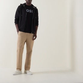 Model wearing Boss Black Casual C-Thompson Logo T-Shirt in black, styled with dark zip-up hoodie, beige chinos and white trainers.