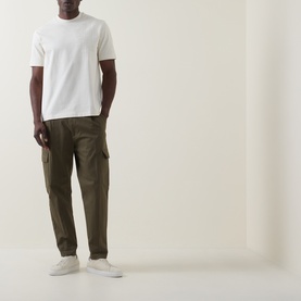 Model wearing Boss Black Casual C-Tigerman Tonal Check T-Shirt in Open White, styled with olive cargo trousers and white trainers.