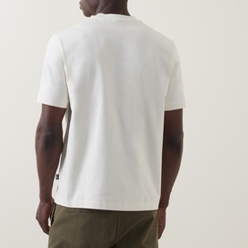 Model wearing Boss Black Casual C-Tigerman Tonal Check T-Shirt in Open White, back view, styled with khaki trousers