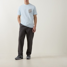 Model wearing Boss Black Casual Tigerman Logo T-Shirt in Open Blue with dark grey trousers and blue trainers