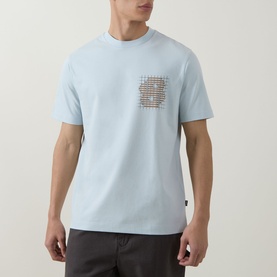 Model wearing Boss Black Casual Tigerman Logo T-Shirt in Open Blue with chest graphic print, crew neck and short sleeves, styled with dark trousers