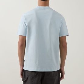 Model wearing Boss Black Casual Tigerman Logo T-Shirt in Open Blue, rear view, crew neck, short sleeves, styled with dark trousers