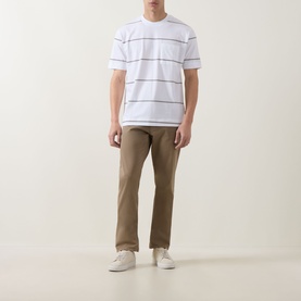 Model wearing Boss Black Casual Tigerman Stripe T-Shirt in white with chest pocket, styled with tan chinos and white trainers.