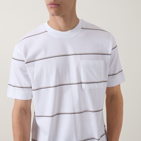 Model wearing Boss Black Casual Tigerman Stripe T-Shirt in white, with horizontal stripes, crew neck, and chest pocket.