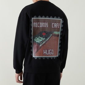 Model wearing Boss Black Casual C-Tigerman Logo Sweatshirt in black, showing rear Records Caf&eacute; graphic print with pixelated design on crew neck style.