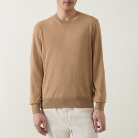 Model wearing Boss Black Casual Leno Knitted Sweater in medium beige, fine-knit crew neck with ribbed trims, styled with white trousers.
