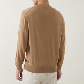 Model wearing Boss Black Casual Leno Knitted Sweater in medium beige, crew neck, fine-knit wool, ribbed trims, back view, styled with white trousers