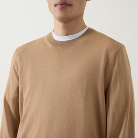 Model wearing Boss Black Casual Leno Knitted Sweater in medium beige, fine-knit crew neck with white T-shirt underneath.