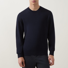 Model wearing Boss Black Casual Leno Knitted Sweater in dark blue, crew neck, ribbed trims, long sleeves, paired with dark trousers.